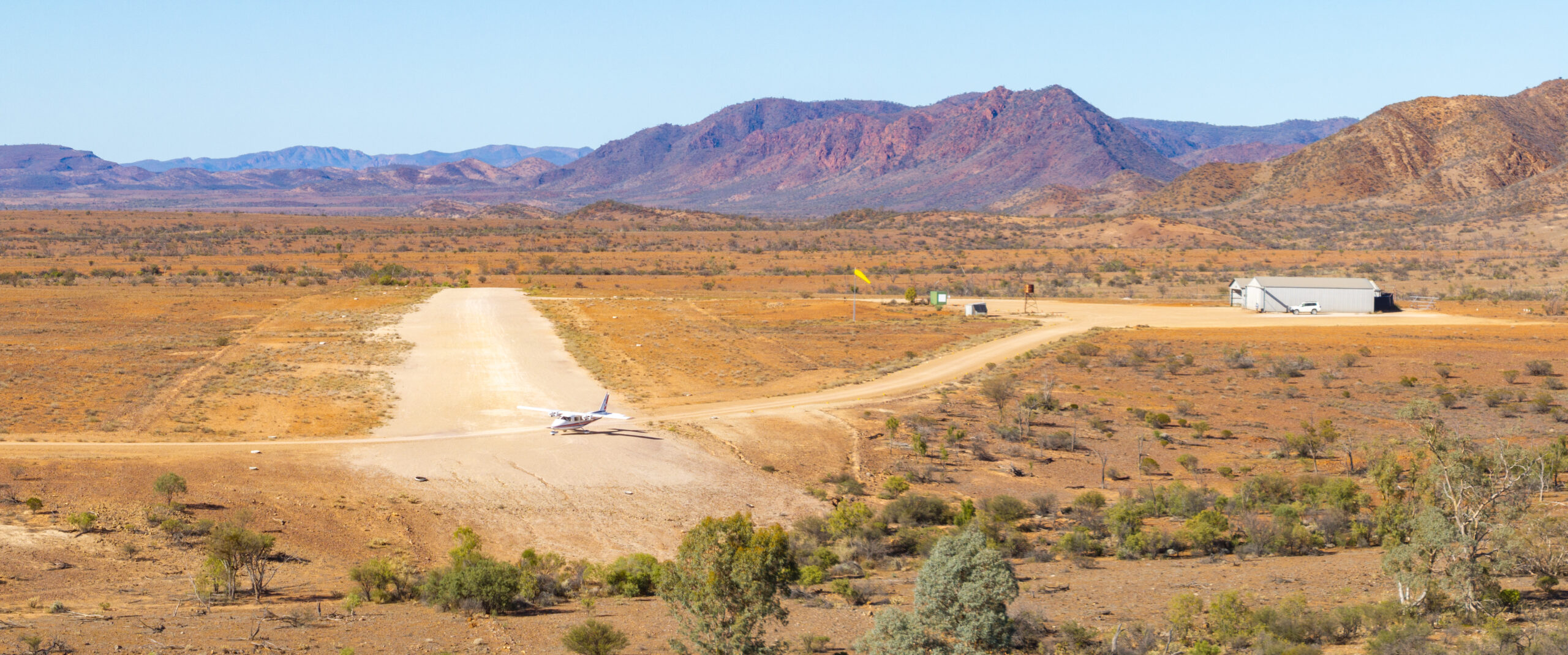 Remote outback airstrip below rugged ranges
