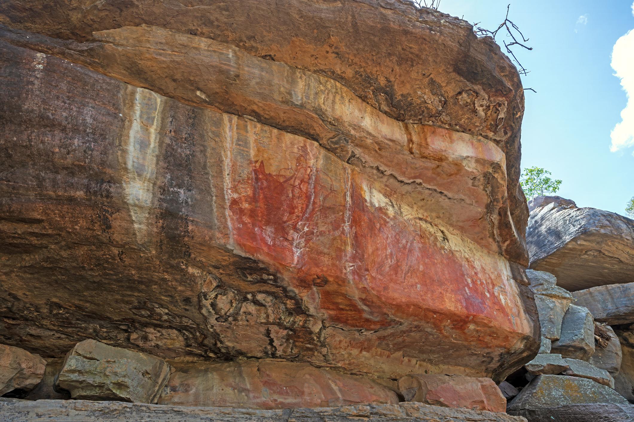 Ochre Aboriginal rock art on a sandstone overhang