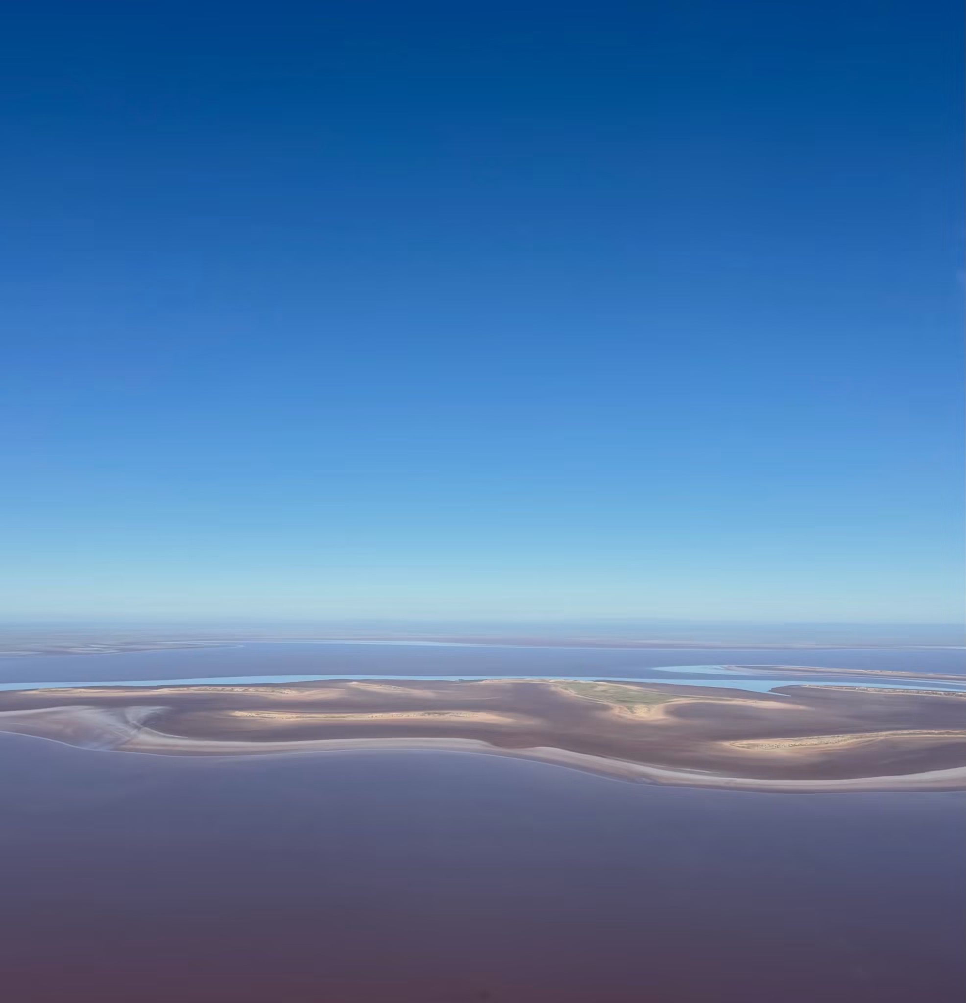 Aerial view of Lake Eyre's waters stretching to the horizon