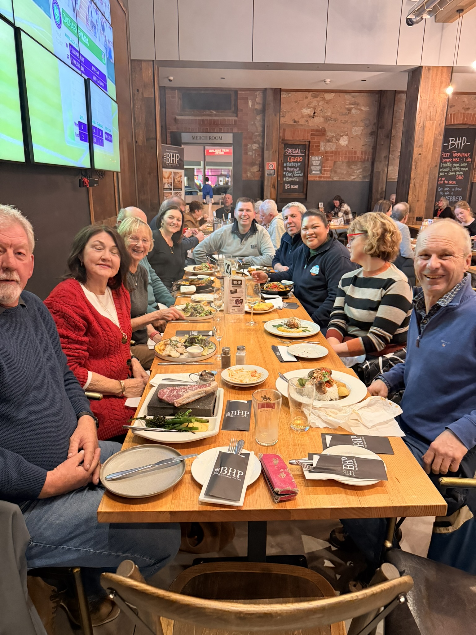 Tour group sharing a long-table dinner at a restaurant