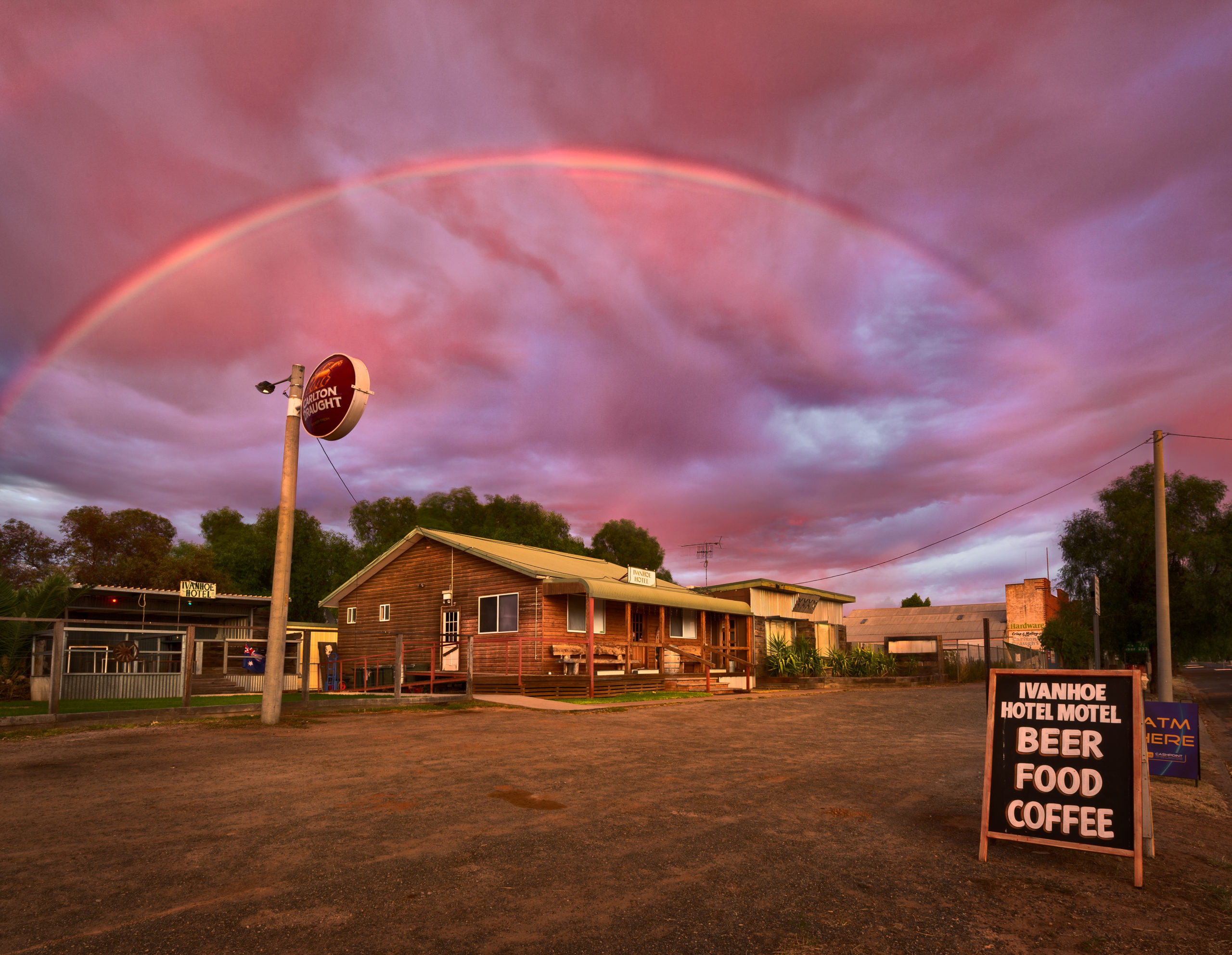 Rainbow over the Ivanhoe Hotel motel at dusk