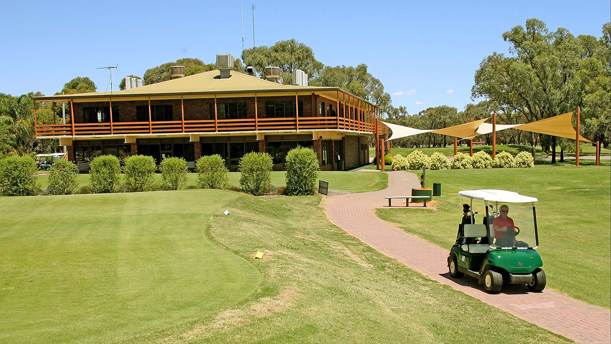 Coomealla Golf Club clubhouse with a golf cart on the green