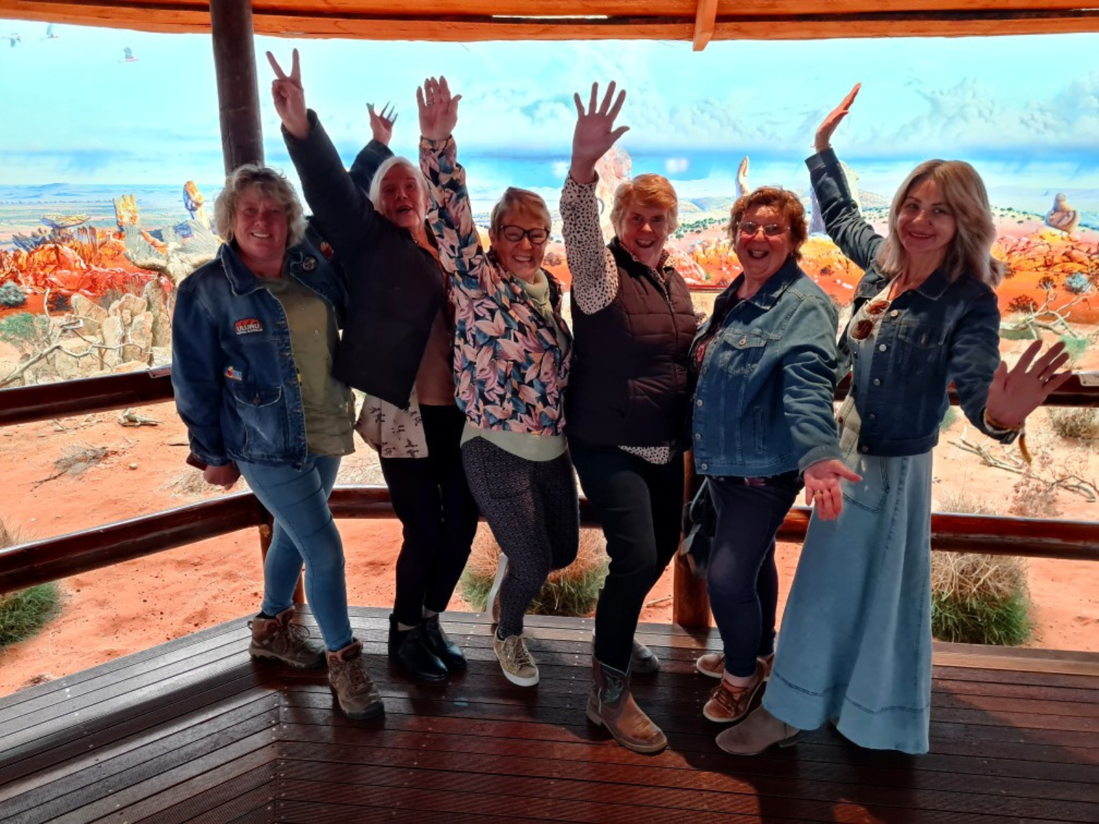 Group of women cheering on a deck during a celebration tour