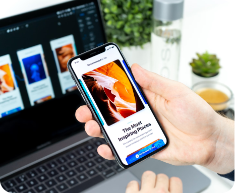 Phone showing a website beside a laptop