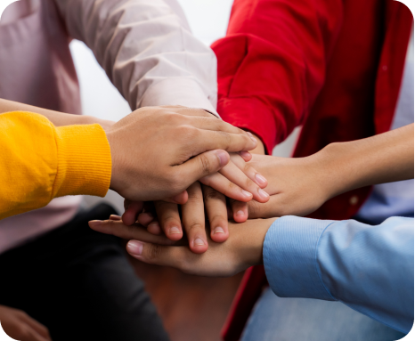 Hands stacked together in a team huddle